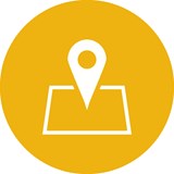 A white location address pin symbol on a yellow background circle