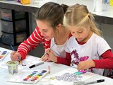 A mother and daughter painting together